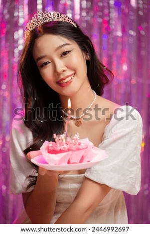 Happy beautiful Asian girl in princess dress showing birthday cake. Birthday princess photography theme is popular in social network. Royalty-Free Stock Photo #2446992697