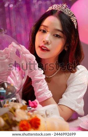 Happy beautiful Asian girl in princess dress showing birthday cake. Birthday princess photography theme is popular in social network. Royalty-Free Stock Photo #2446992699