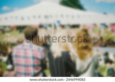 Multiethnic friends having fun - Group of young people enjoying summer vacation together - Friendship concept with guys and girls hanging outside on a sunny day. Blurred image concept 