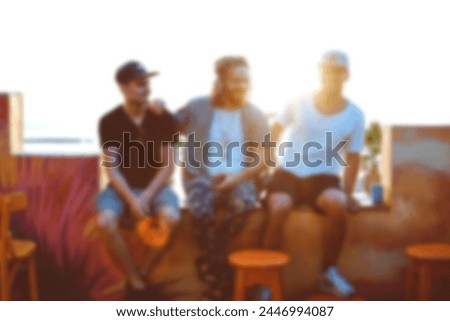 Multiethnic friends having fun - Group of young people enjoying summer vacation together - Friendship concept with guys and girls hanging outside on a sunny day. Blurred image concept 