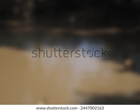 Black-gray water and blurred yellow-white light serve as the background.