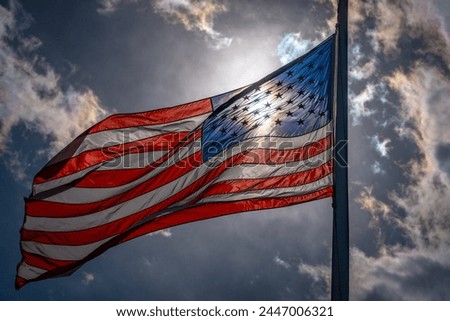 American election and vote concept. US Flag. Waving american flag on dark dramatic sky. USA flag.