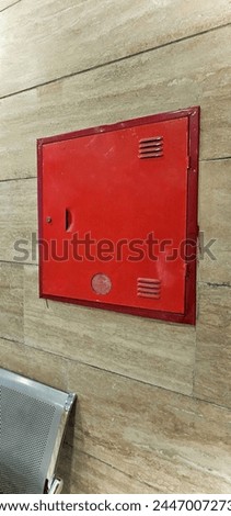 fire cabinet, red color. Wall mounted fire hydrant box located inside the building, ready for use in an emergency situation.