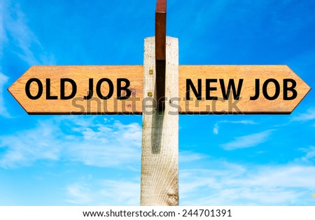 Wooden signpost with two opposite arrows over clear blue sky, Old Job and New Job, Career change conceptual image Royalty-Free Stock Photo #244701391