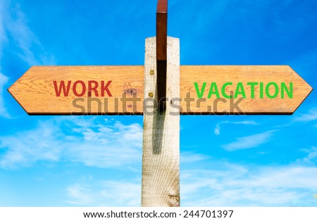 Wooden signpost with two opposite arrows over clear blue sky, Work and Vacation signs, Work Life Balance conceptual image