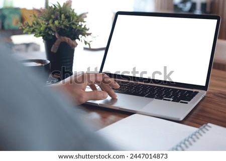 Mockup blank screen laptop computer. Business woman working on laptop computer at home office, planning work project on notebook. Student studying online via laptop, template for online marketing