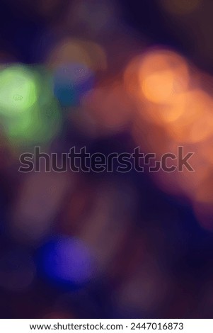 Defocused neon glow. Overlaying highlights. Colored bokeh. Futuristic LED lighting. Blur of colors on dark abstract background