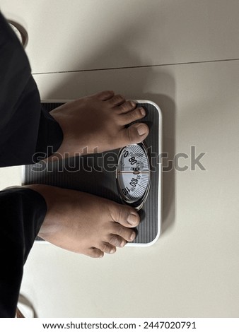 An obese person weighing 90kg Royalty-Free Stock Photo #2447020791
