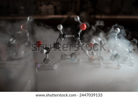Smoky experiments with molecular model. Scientist working on chemical reaction, generating thick smoke. Copyspace