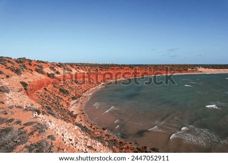Aerial picture of Cape Peron in Shark bay, Western Australia. Orange land next to the beach and the ocean. Breathtaking view in an australian national park.