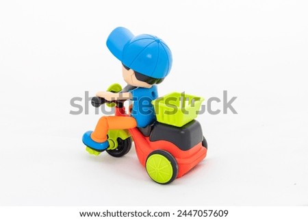 Plastic toy cycle with delivery box on white isolated background