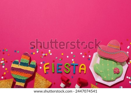 The inscription Fiesta with decorations on a pink background