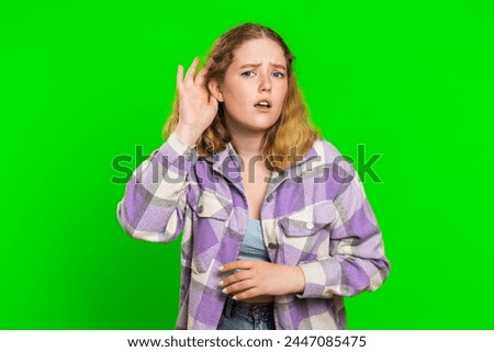 I cant hear you. What. Young woman trying hear you, looking confused and frowning, keeping arm near ear for louder voice, asking to repeat, to hear information, deafness. Girl on chroma key background Royalty-Free Stock Photo #2447085475