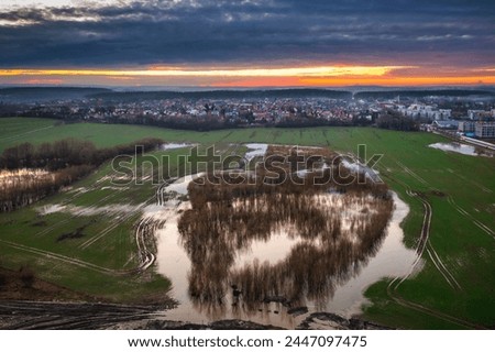 Amazing sunset over the wet spring fields in Poland