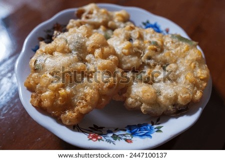 Corn bakwan food in a white plate on the table, stock photo, traditional food, Indonesian food.