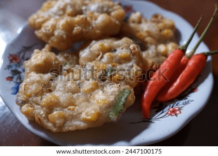 Bakwan corn and red chili food in a white plate on the table, stock photo, traditional food, Indonesian food.