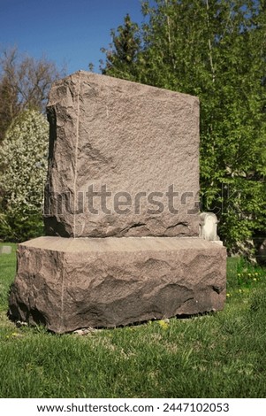 A simpe worn and weathered gravestone standing in the old cemetery with a blank epithet. Royalty-Free Stock Photo #2447102053