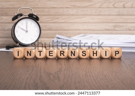 wooden cubes spelling 'INTERNSHIP' symbolize opportunities for gaining practical experience and professional development within a specific field or industry through temporary work placements