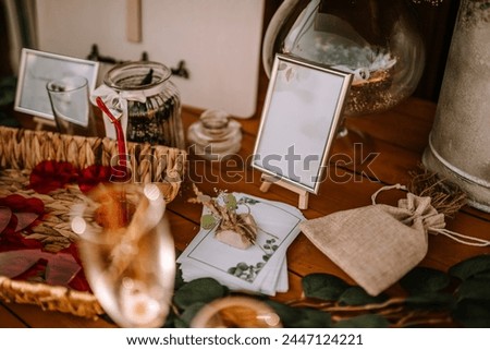 Valmiera, Latvia - Augist 13, 2023 - A table setting with a framed blank sign, burlap pouch, and decorative items.