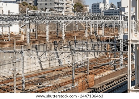 Abstract industrial background featuring detail of electrical railroad with rails and contact lines illustrating modern urban transport and mass transit concept, near Ueno station in Tokyo, Japan.