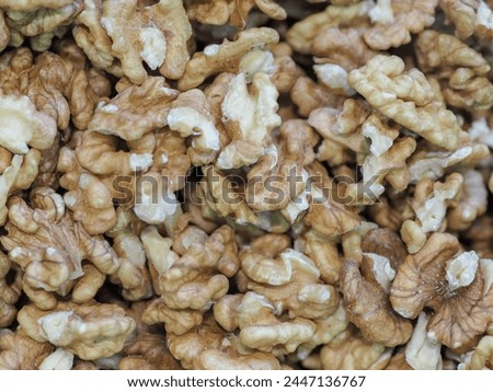 “Close-up of Walnut Kernels on a Dark Background, Symbolizing Natural Strength and Energy”