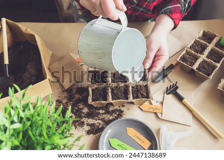 Woman's hands plant seeds at home. Home gardening, hobbies and agrarian life during lockdown. The concept of ecological and plant economy. Earth Day. Royalty-Free Stock Photo #2447138689