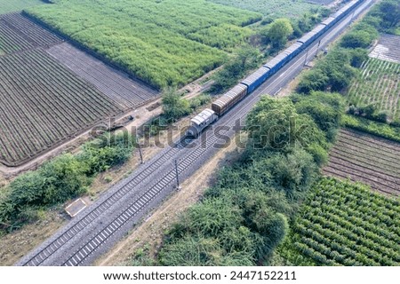 Aerial footage of a freight train in the countryside near Pune India. Royalty-Free Stock Photo #2447152211