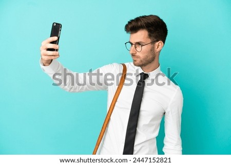 Business man over isolated background making a selfie
