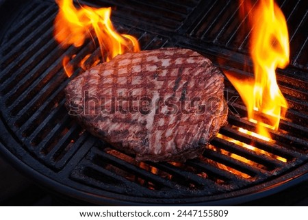 Traditional American barbecue flanksteak steak as close-up on a charcoal grill with fire  Royalty-Free Stock Photo #2447155809