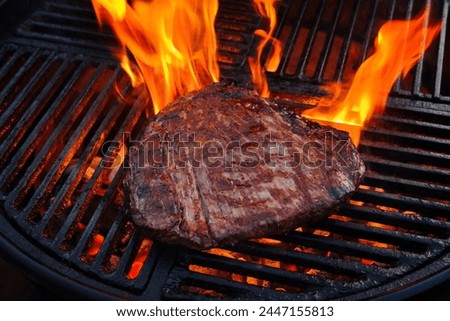 Traditional American barbecue flanksteak steak as close-up on a charcoal grill with fire  Royalty-Free Stock Photo #2447155813