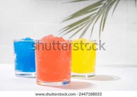 Colorful slushie drink, multicolored frozen juice cocktail, summer tropical crushed ice beverage  Royalty-Free Stock Photo #2447188033