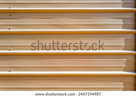 Linear texture of the outer wall of a corrugated metal building