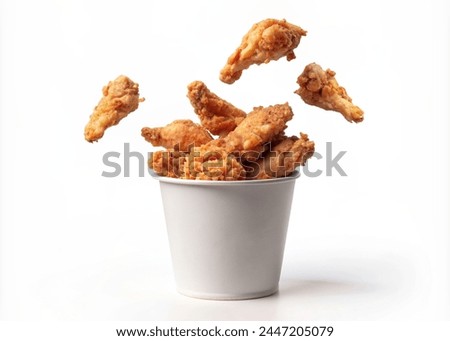 Fried chicken flying out of paper bucket isolated on white background, Fried chicken on white With clipping path.
 Royalty-Free Stock Photo #2447205079