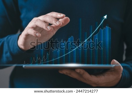 BusinessMan hand using tablet checking stock market graph report via mobile app. finance and investment, trading, currency exchange, economic growth, stock market analysis concept.	
