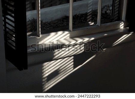 Morning light shining through window blinds                               