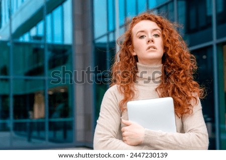 a young redhead unhappy  woman  in white shirt talking and using on her mobile phone, using mobile in an urban modern city. Lifestyle photos