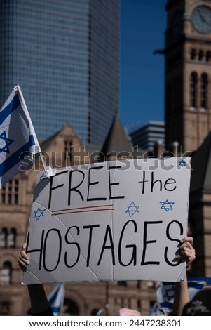 A free the hostages sign at an Israeli rally marking six months of war.