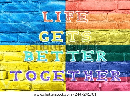 A colorful sign that says Life gets better together. The sign is made up of different colors and is placed on a brick wall