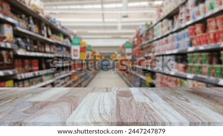 Wooden table top (counter bar) with blur supermarket grocery store background. Banner for advertise on online media. For montage product display visual layout. Business and shopping concepts.