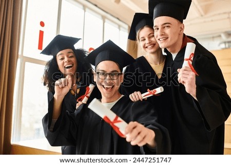 A diverse group of students in graduation gowns and caps joyfully posing for a picture to commemorate their academic success.