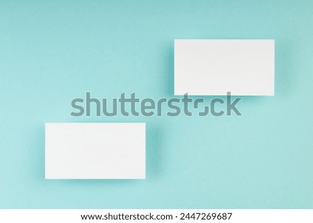 Business card blank over colorful abstract background. Corporate stationery branding mock-up. Copy space for text. Top view