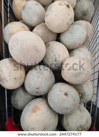 Stunning close-up of Shamam fruit (Musk melon) kept on a steel carrier fruit market kept ready for sale ultra hd hi-res jpg stock image photo picture selective focus vertical background top view 