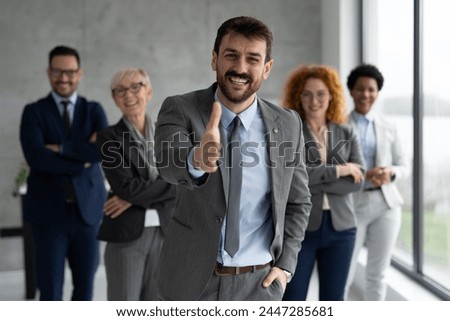 Group of business people standing and looking at camera at office