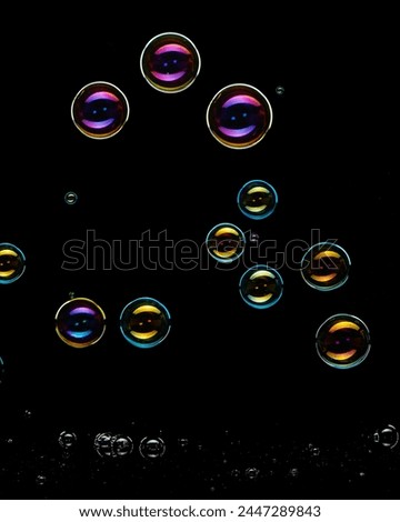 Colorful soap bubbles on black background