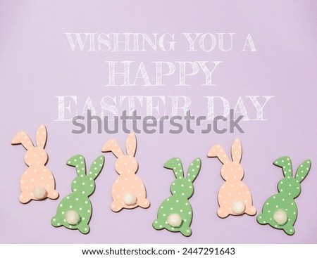 A group of Easter bunnies are sitting on a purple background. The bunnies are in various colors and sizes, and they are all smiling. The background is a light purple color
