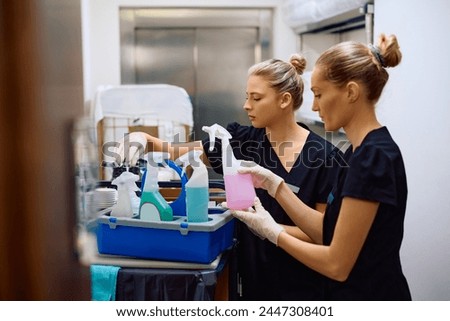 Two maids preparing for housekeeping work in a hotel. Royalty-Free Stock Photo #2447308401