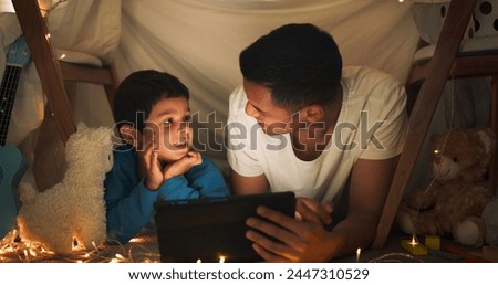 Night, father and boy on tablet in tent watching movies, online games and cartoon by blanket. Family, happy and dad with son and fairy lights in bedroom on digital tech for bonding, relax and love