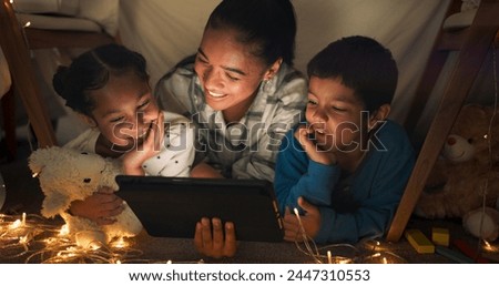 Funny, tablet and mother with children in a tent house streaming internet video, show or movie online in the night. Dark, digital and parent or dad relax with kids watching comedy in the evening