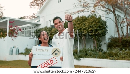 Property, keys and a homeowner couple with a sold sign in the garden of their new house together. Love, mortgage or real estate investment with a married man and woman in the yard for home ownership