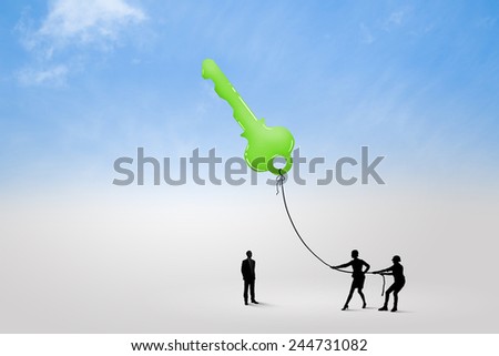 Silhouettes of business people pulling key with rope